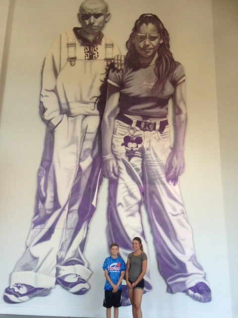 Color Harmony en la Esquina (Gustavo y Karina) person for scale from the barrio fine art portfolio by Gaspar Enriques